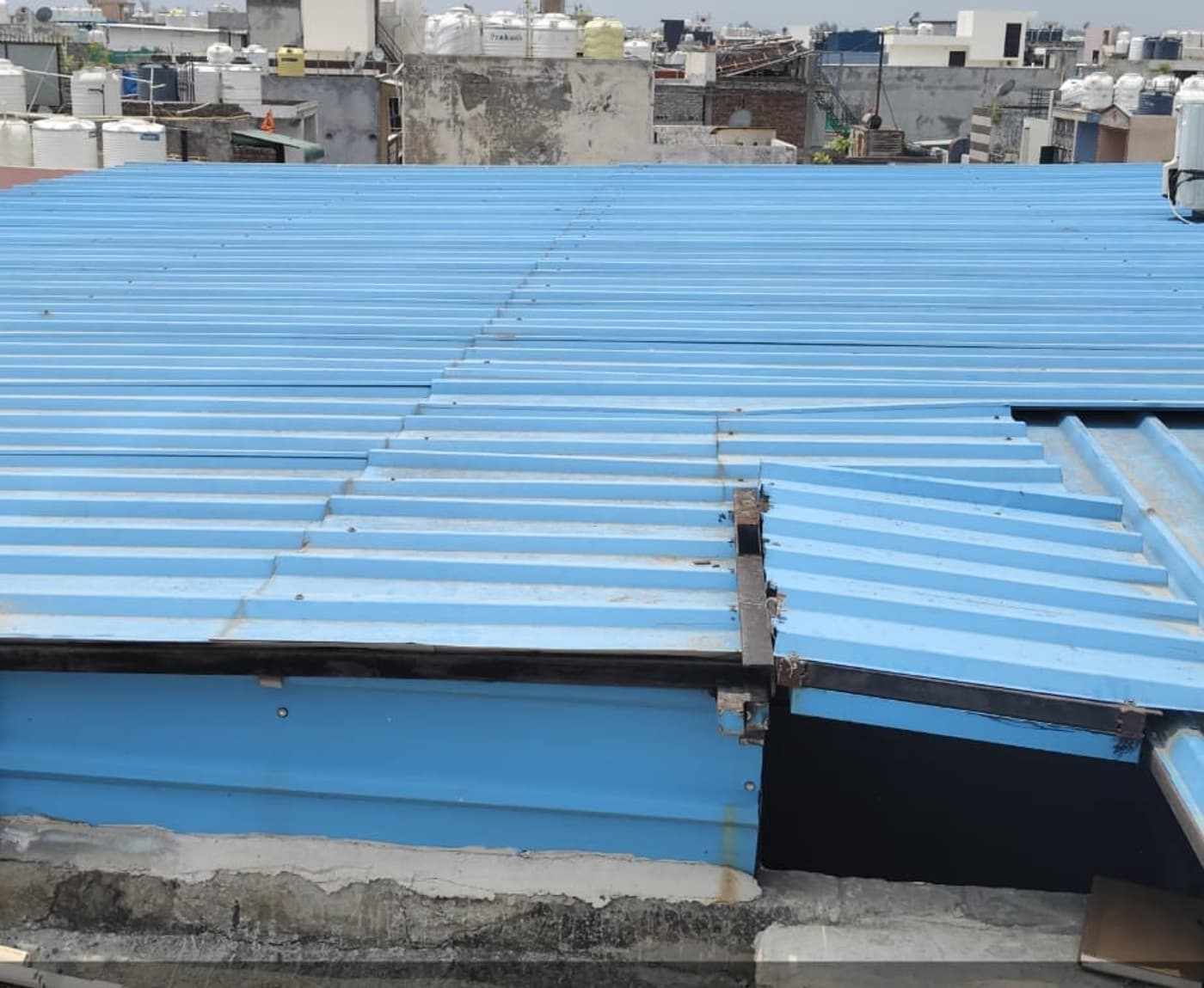 Before installation, the top floor had an existing tin shed that needed a careful mounting and access plan.