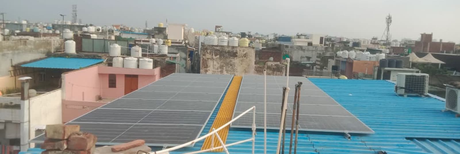 The system design converted an existing tin-shed roof into productive solar area while keeping site conditions in view.